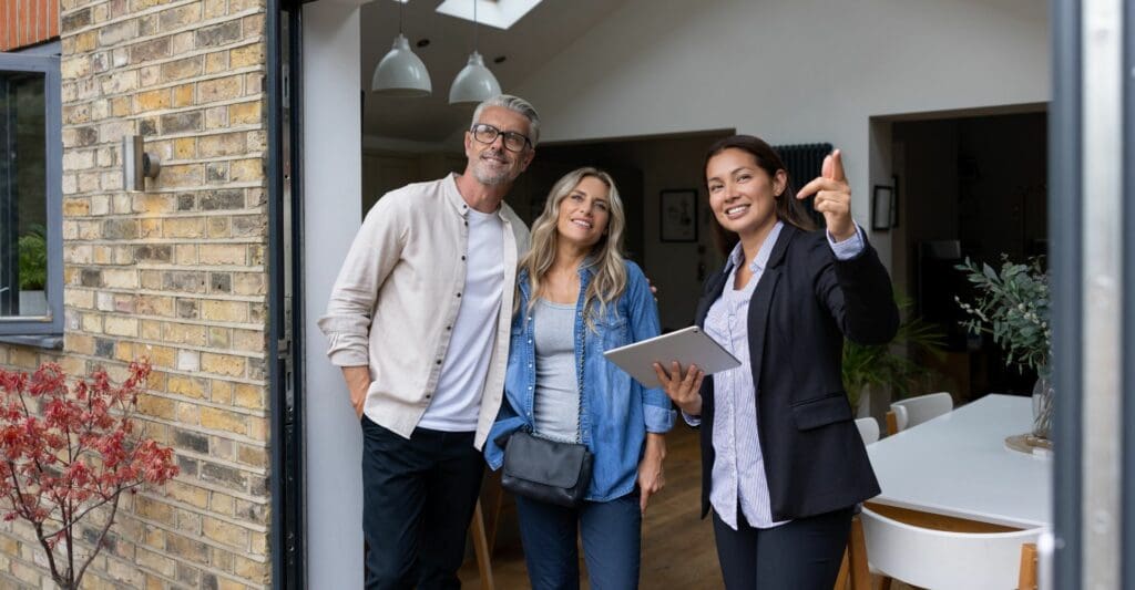 Estate agent showing the outside of a house