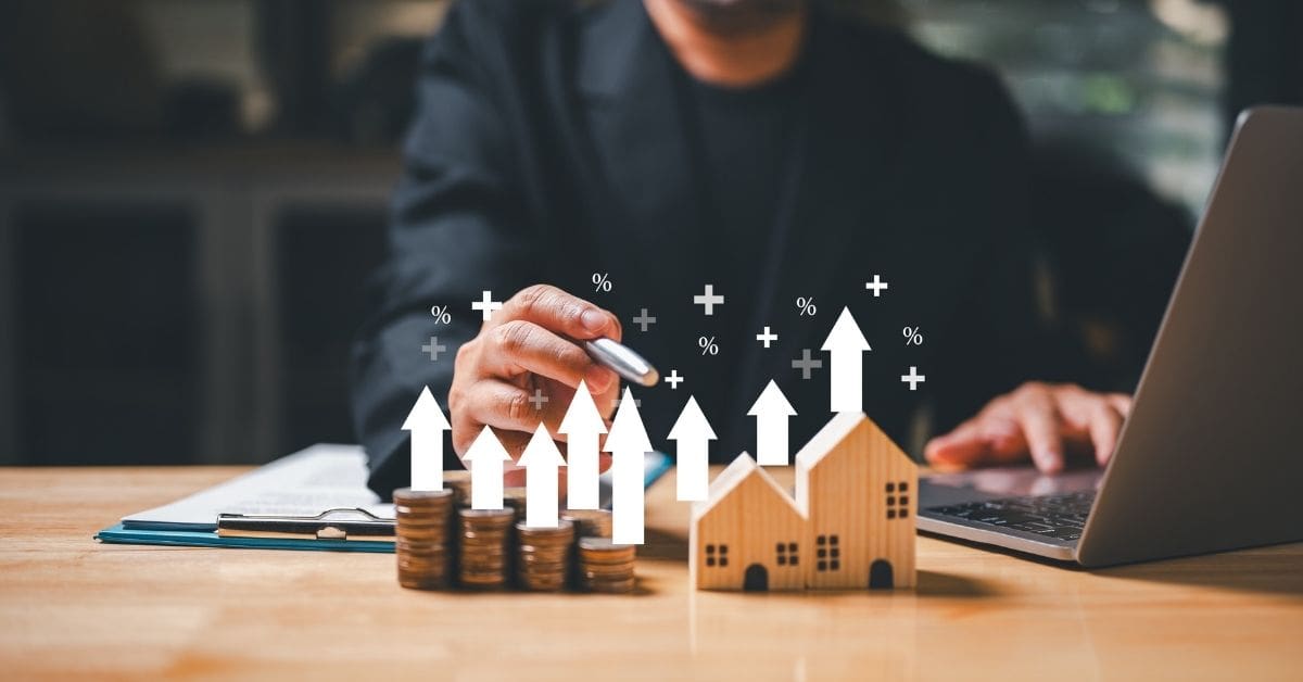 Someone looking at bar and percentage symbols hovering over wooden houses.